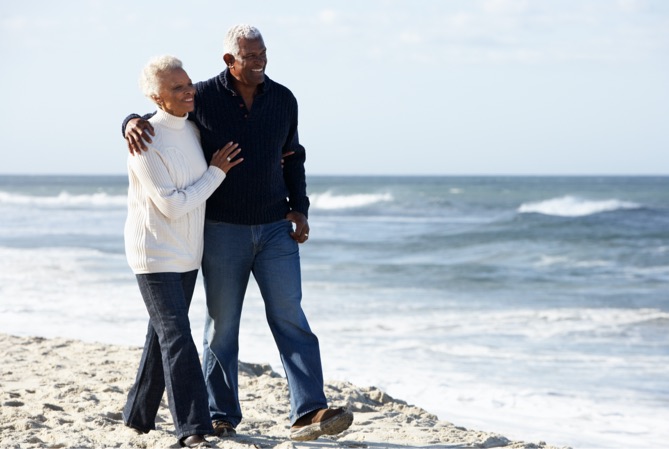 Vacationing couple walking on the beach.