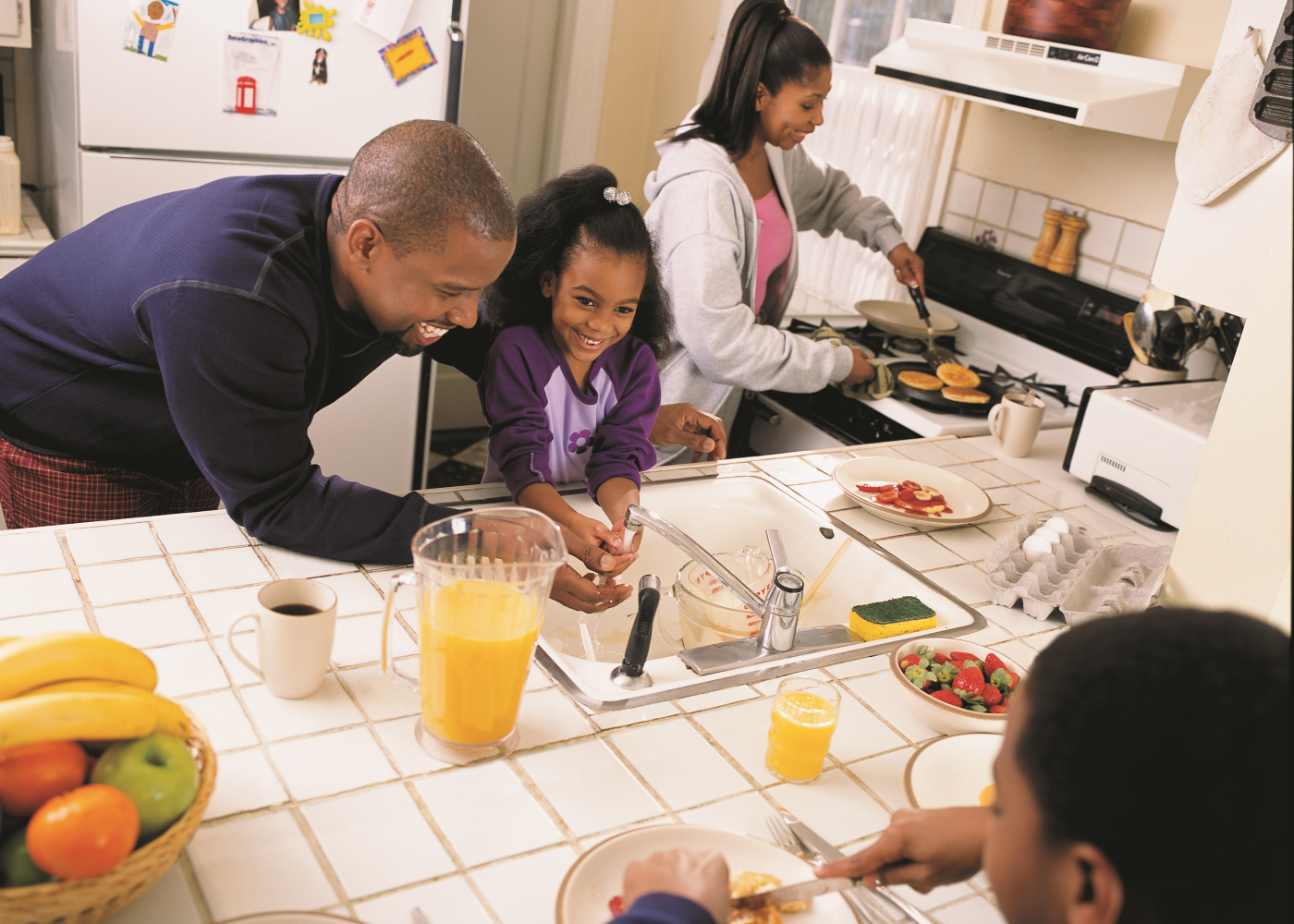 a family prepares dinner together