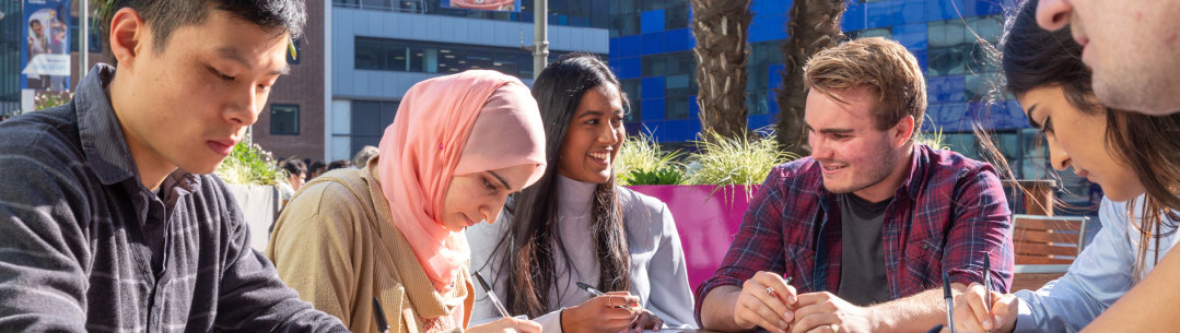 Students sitting in the sunshine on Dalby Court