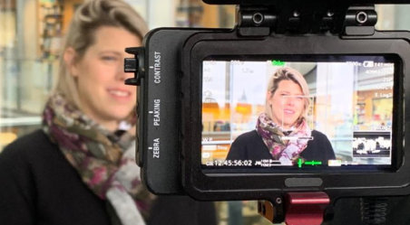 A woman in front of a TV camera