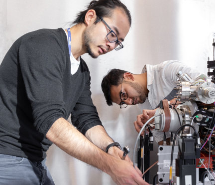 Two engineers working on some machinery