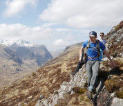 Two students walking along a rocky Alpine path