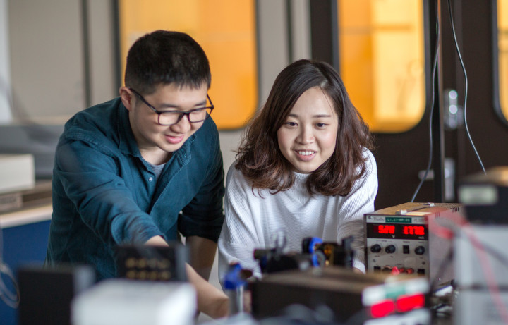 Two students working and smiling in electrical engineering lab