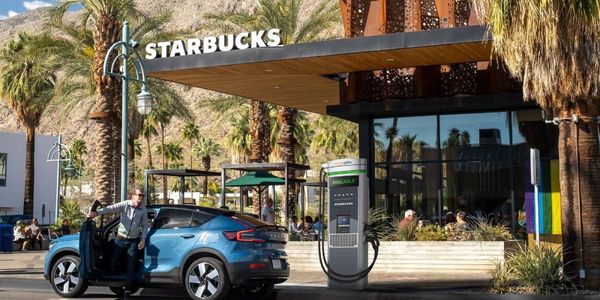 This conceptual photo shows a Volvo C40 all-electric Recharge at a charging station in front of...