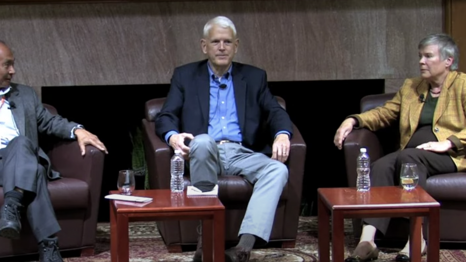 three people sitting on armchairs