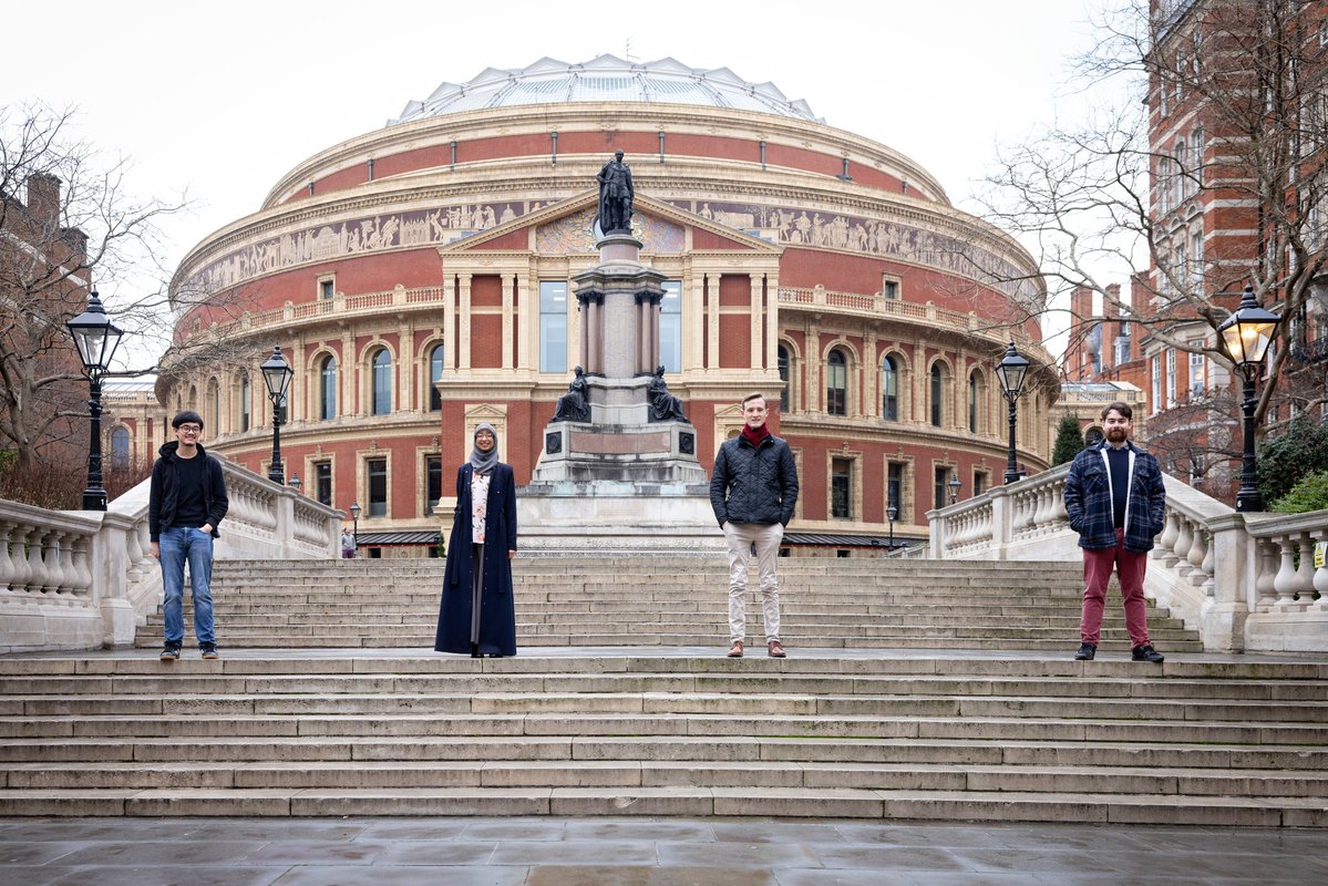 Four people stand in a row outside Royal Albert Hall