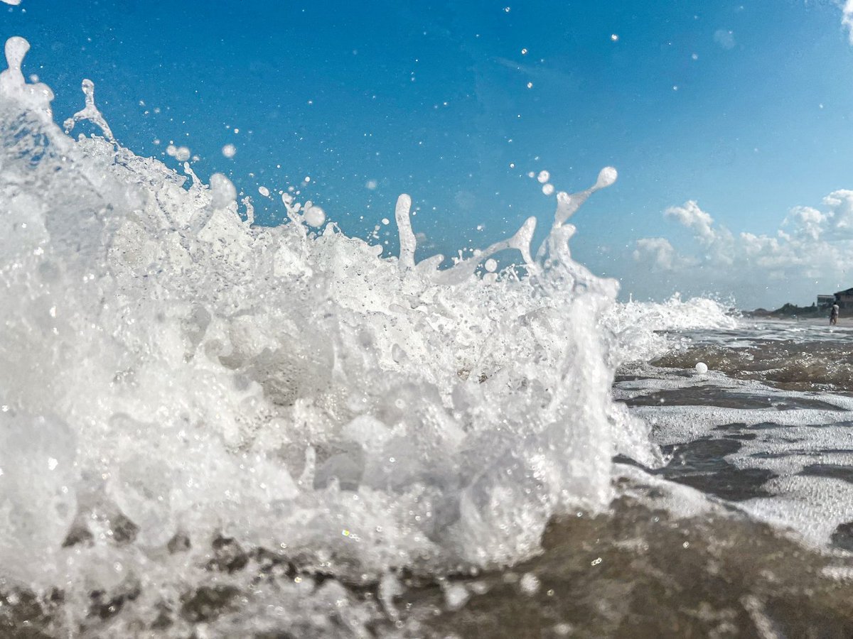 Close-up of wave crashing at the beach.