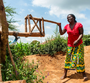 Woman operating wooden agricultural tool