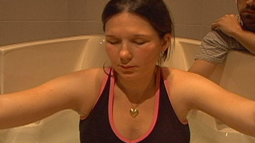 woman in bra in large bath tub