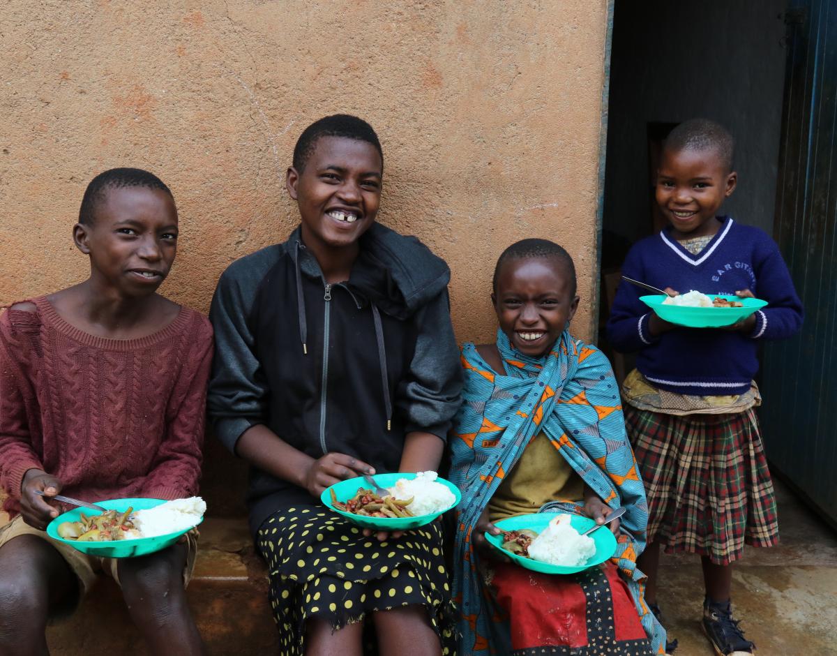 Children smiling with plates of food