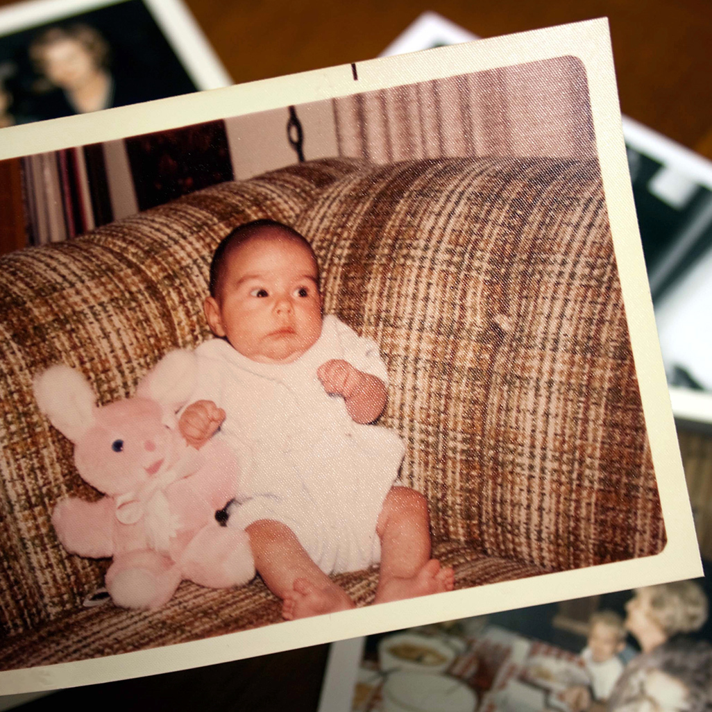 small baby holding a stuffed animal's hand