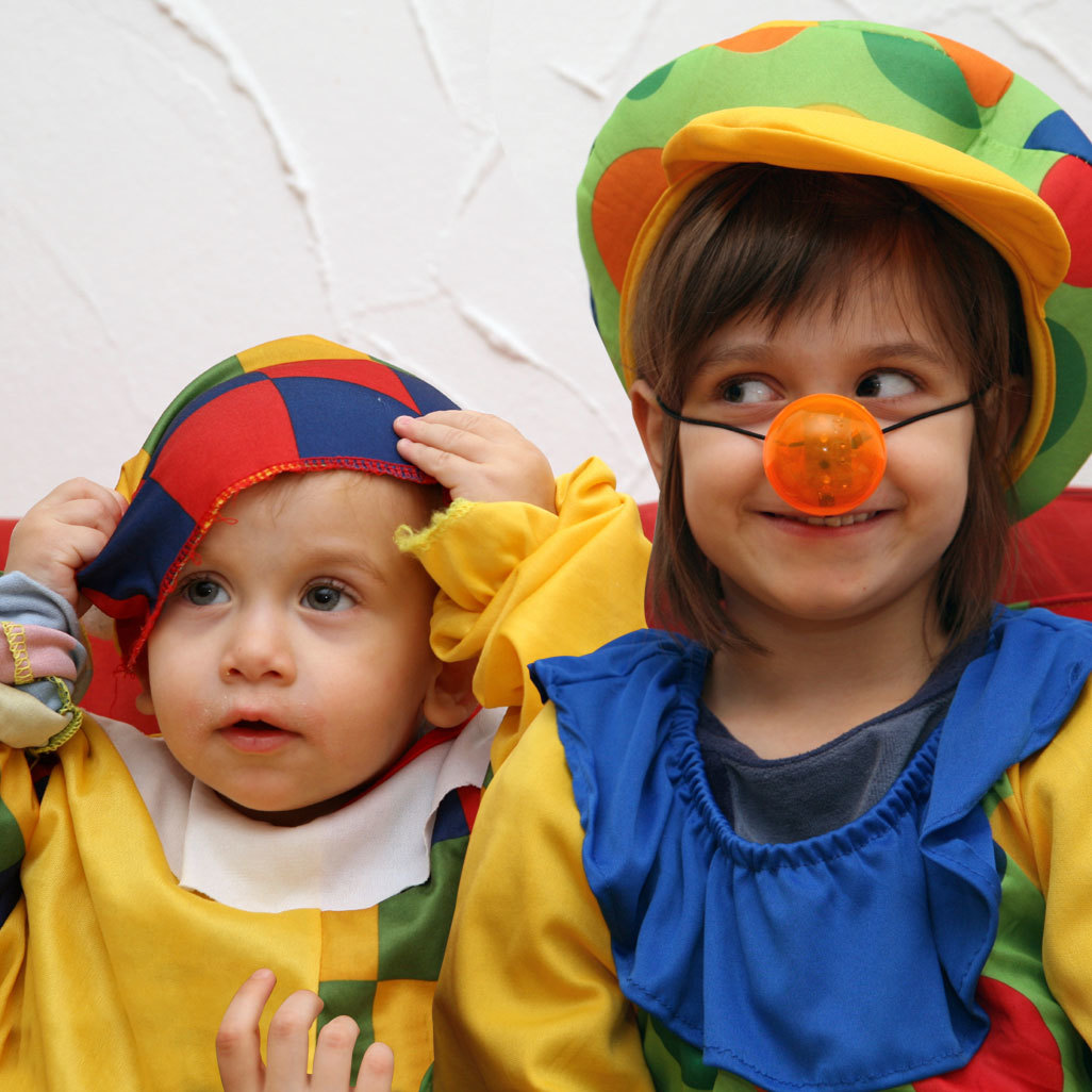 two young children wearing colorful costumes