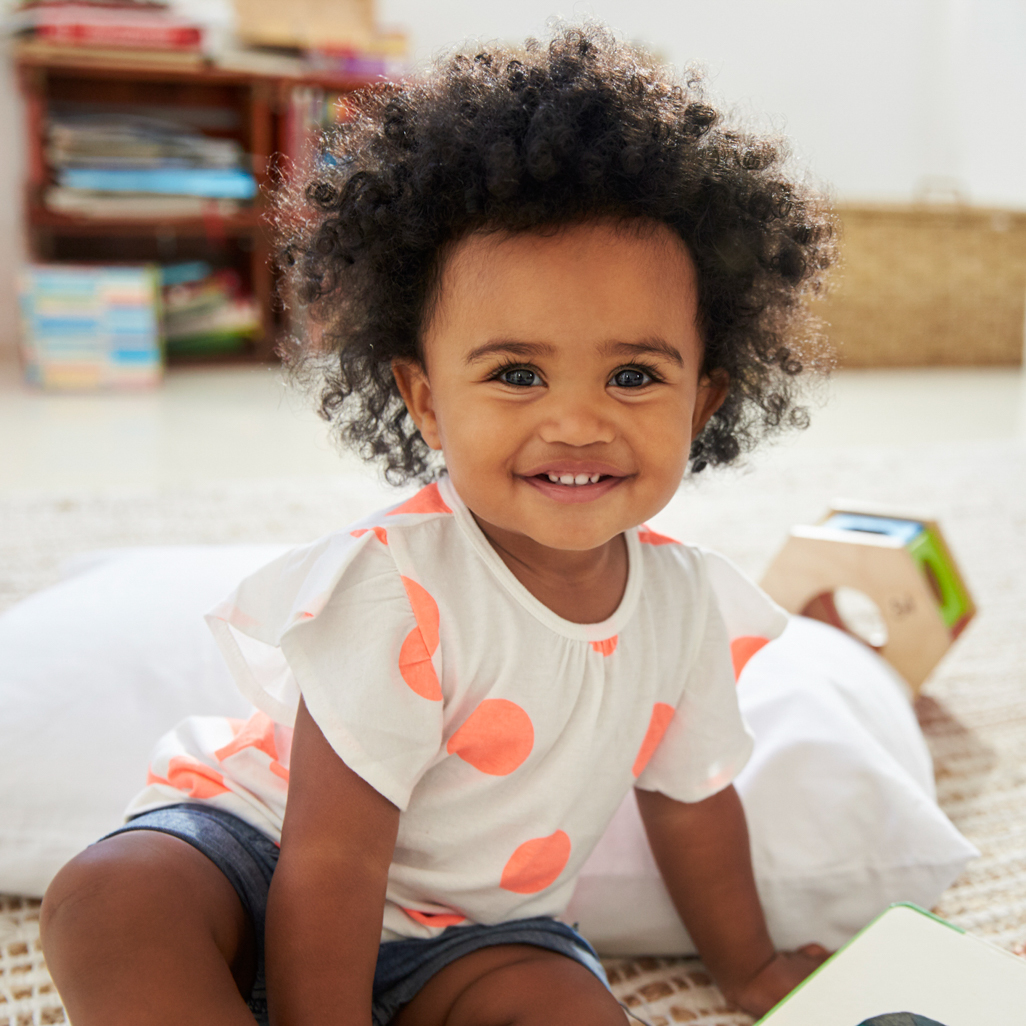 toddler girl playing on floor