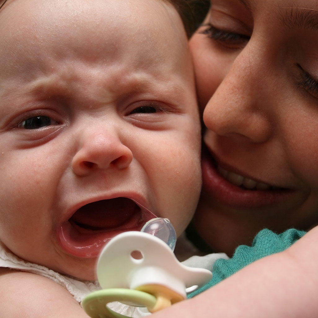 mom holding screaming baby