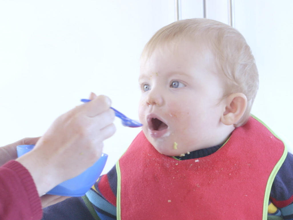 toddler eating and making a mess