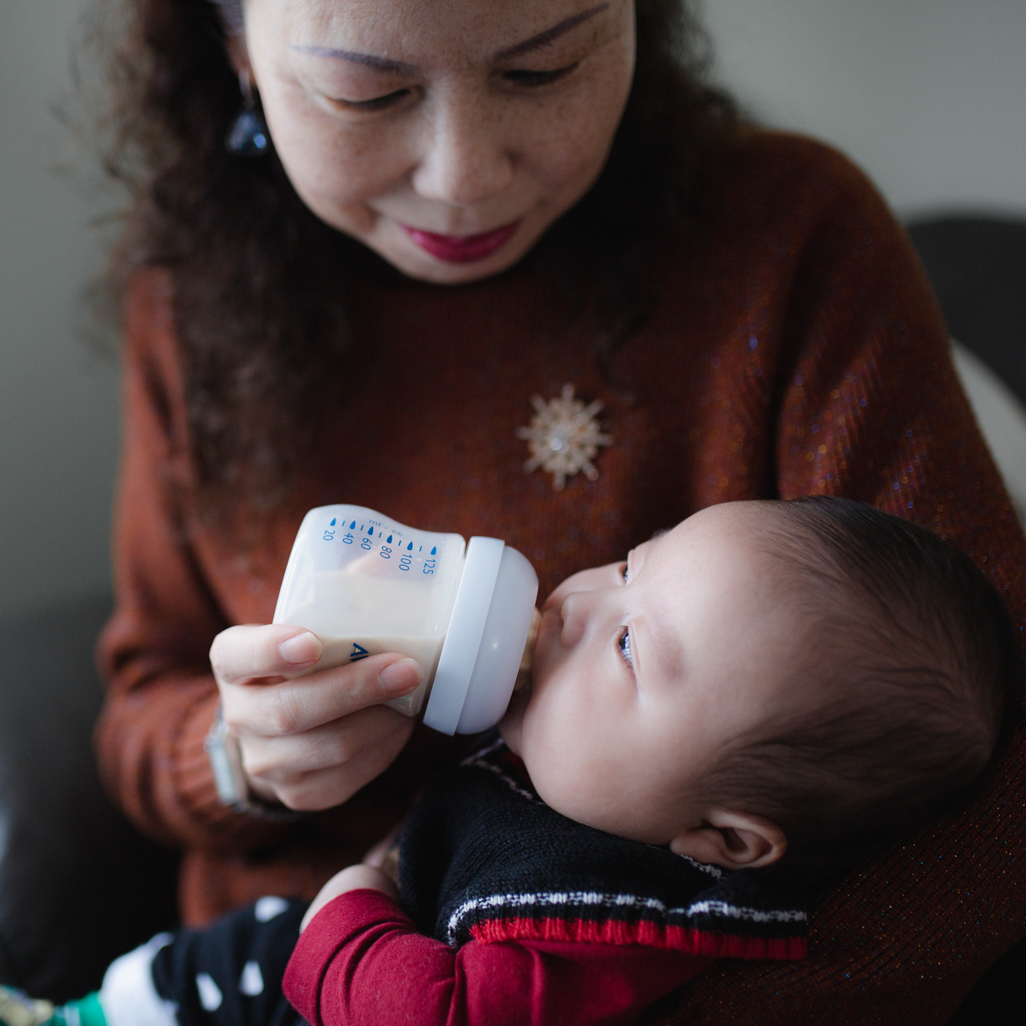 Grandmother bottle feeding a baby 