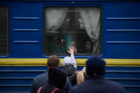 Ukraine. Families look out from a train.