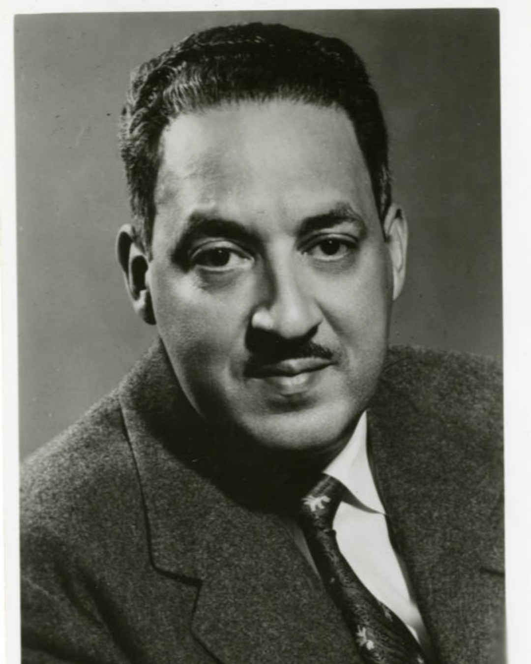 Black and white headshot image of Thurgood Marshall wearing a dark suit and tie. 1956. 