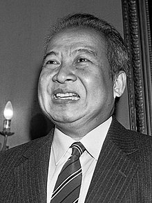 A black-and-white photograph of King Sihanouk smiling