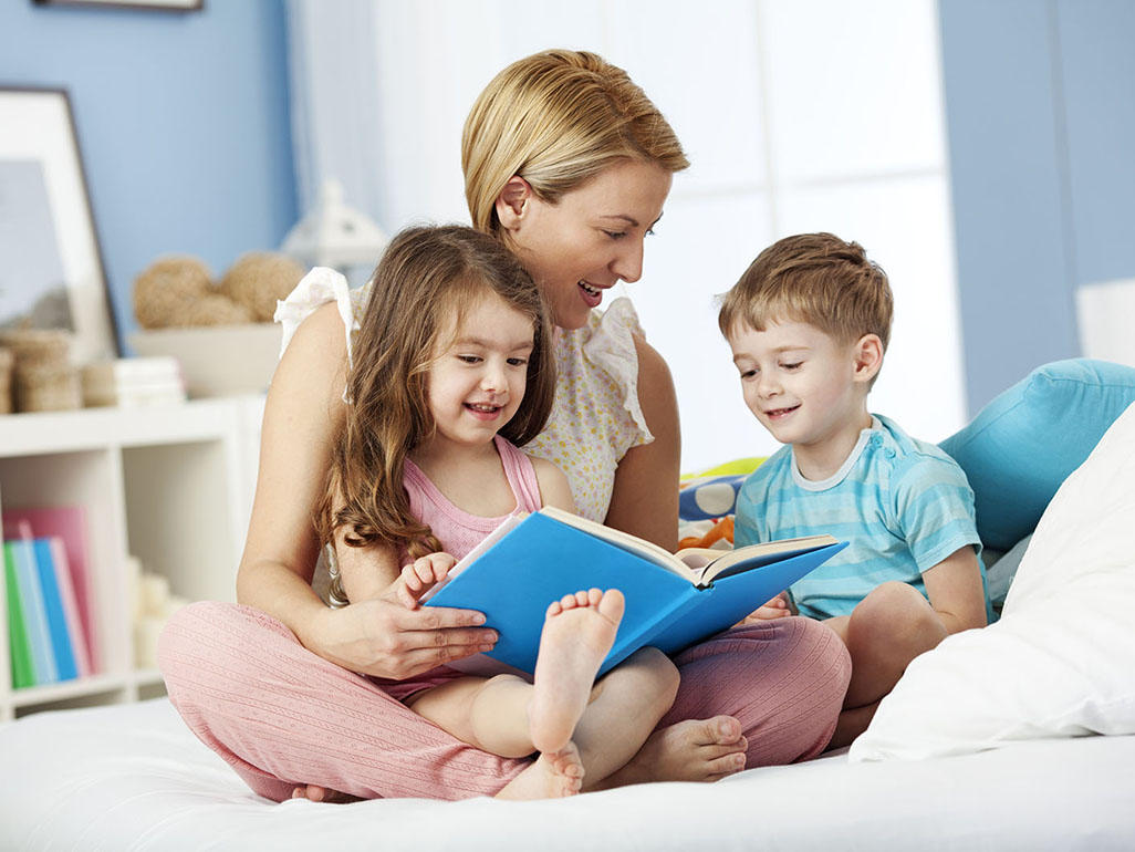 Mum with two children looking at a book