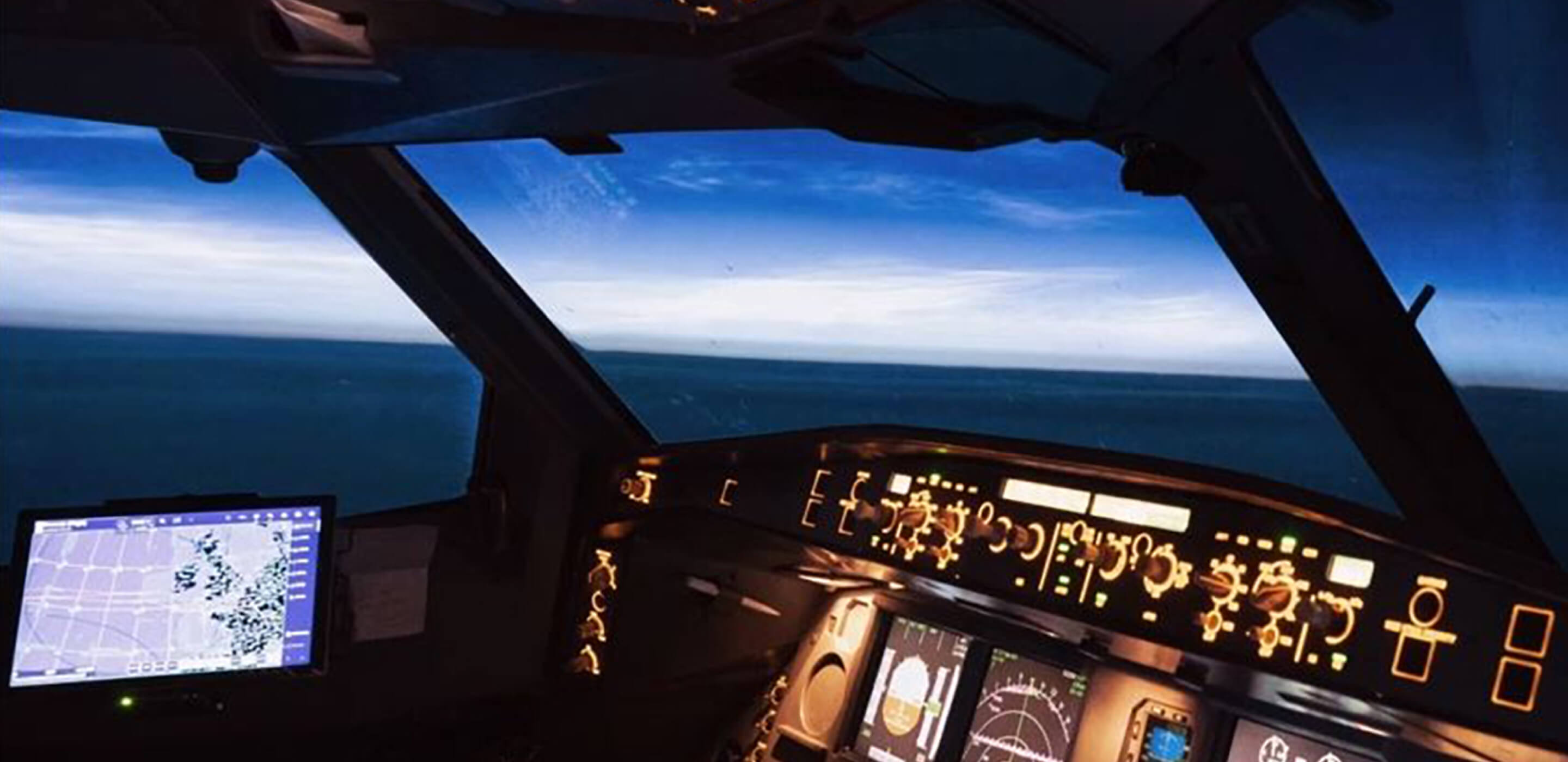 Illuminated control panel in a darkened airplane cockpit.