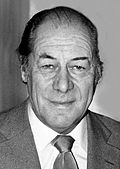 Black and white portrait of Rex Harrison at his home in London in 1976.