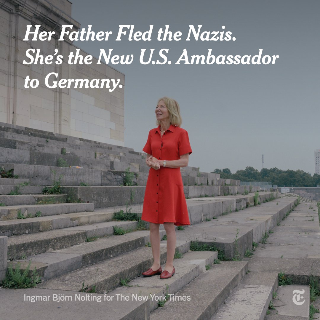 The U.S. ambassador to Germany, Amy Gutmann, stands on outdoor steps in Nuremberg wearing a red dress. Photo by Ingmar Bjorn Nolting.