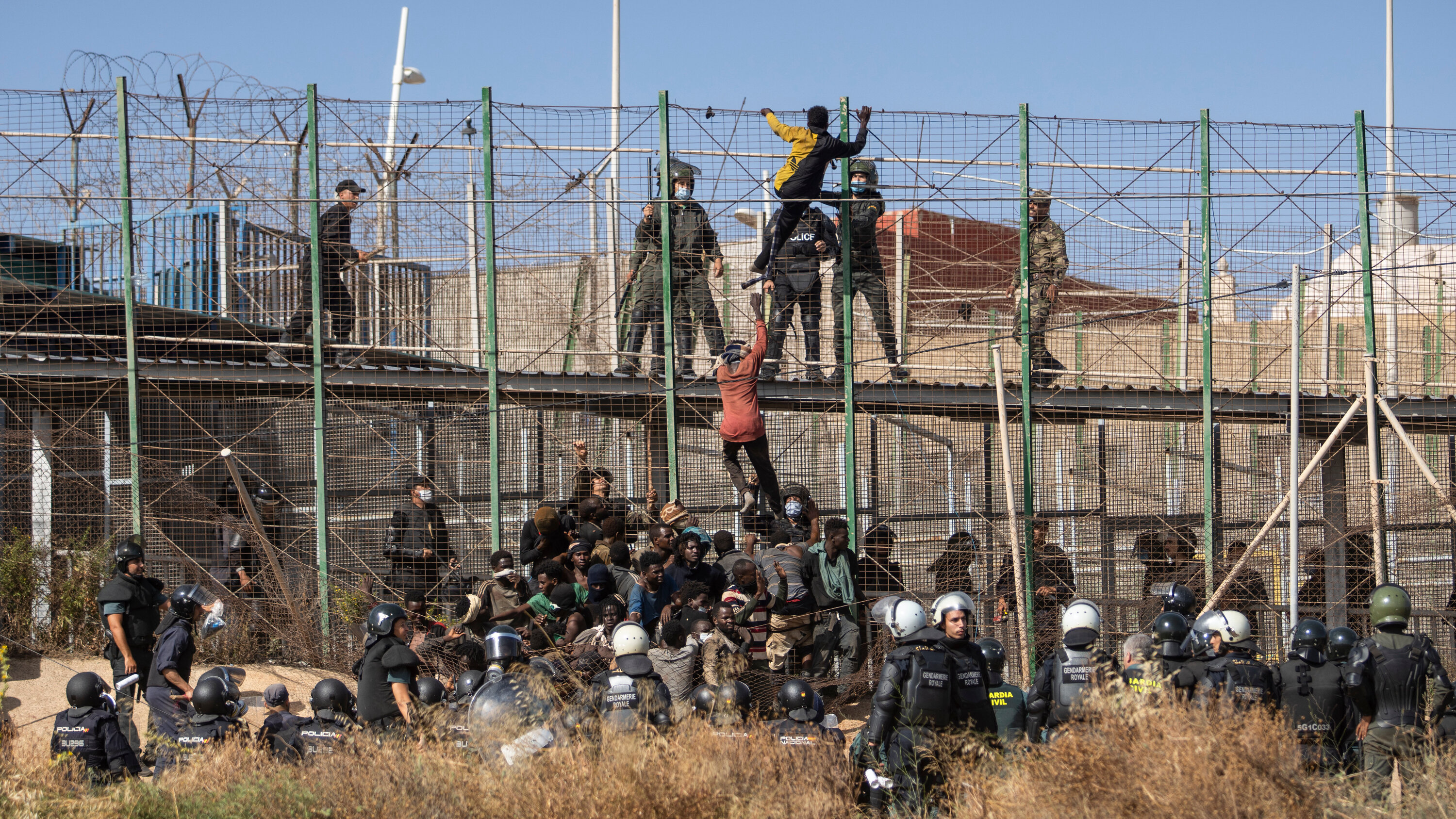 Migrants climbing the fences separating the Spanish enclave of Melilla from Morocco on Friday. Melilla and Ceuta, another Spanish enclave, have the European Union’s only land borders with Africa.