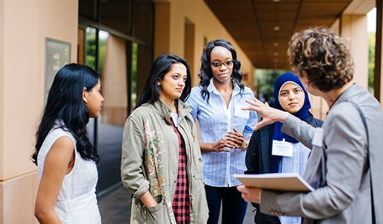 students meeting with faculty