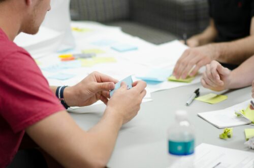 People At Desk With Sticky Notes Free Stock Picture