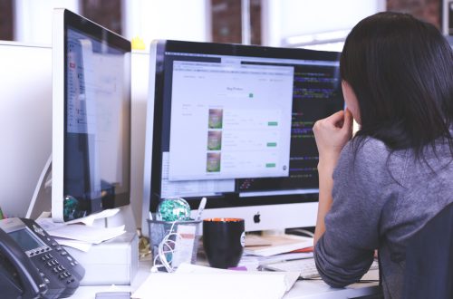 Person Working On Dual Monitors Free Stock Picture