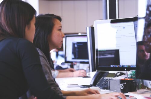 People Working On Multiple Computer Monitors Free Stock Picture