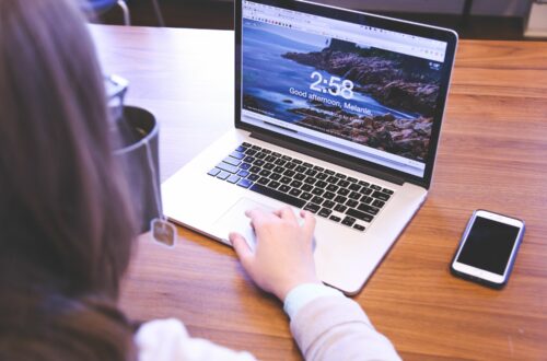 Person Drinking Tea While Looking At Laptop Free Stock Picture