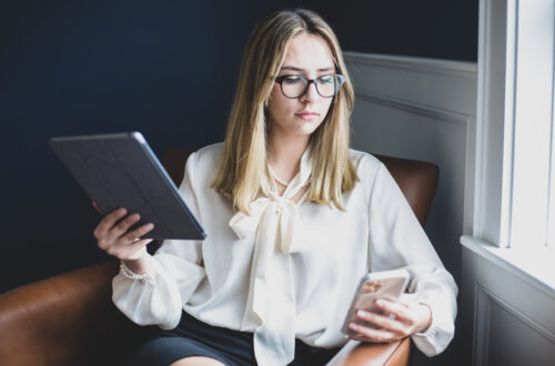 Woman Working On Tablet and Cell Phone Free Stock Picture