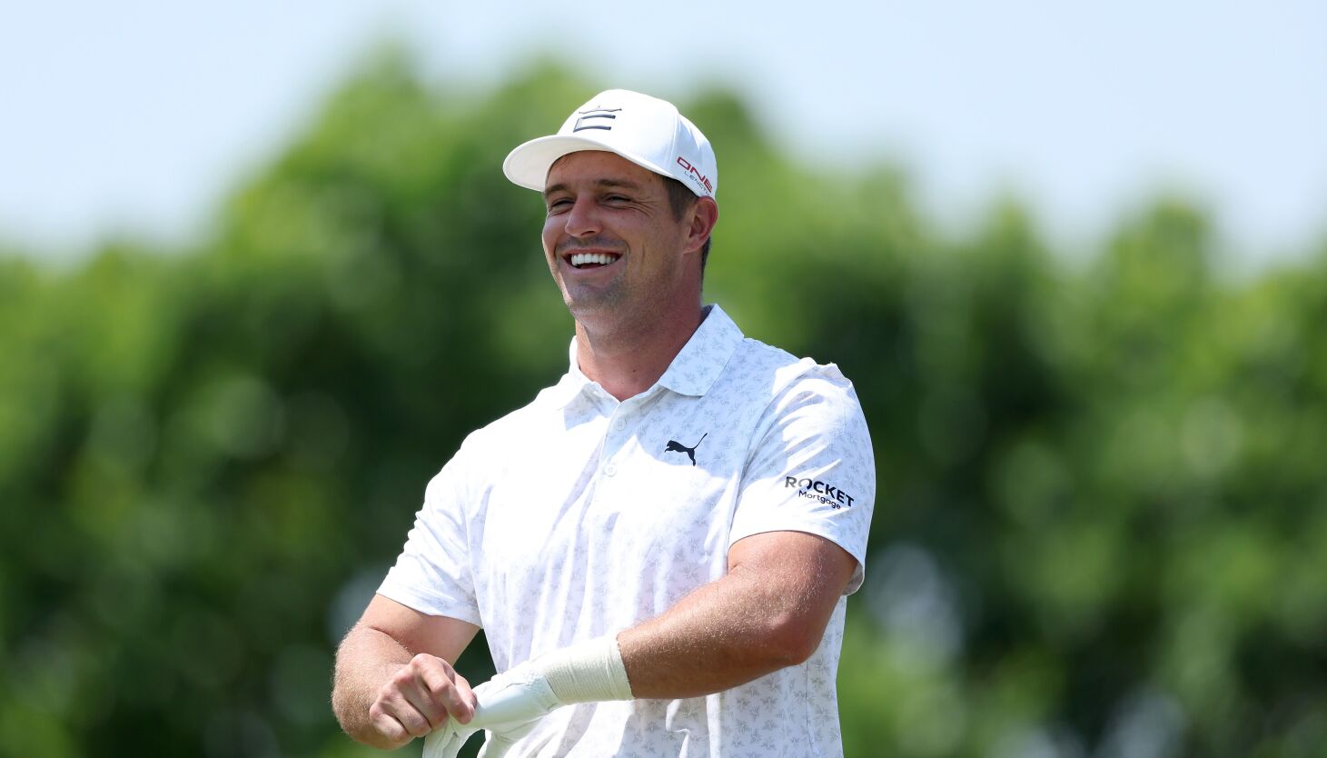 Bryson DeChambeau adjusts his glove during a practice round for the PGA Championship last month.