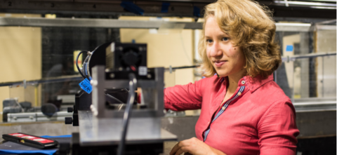 Woman in lab looking at equipment