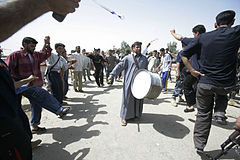 Iraqi civilians play music and dance at a ceremony commemorating the opening of a civilian road outside Forward Operating Base Omar, near Karmah, Iraq, April 14, 2008, during Operation Iraqi Freedom 080414-M-RF524-010.jpg