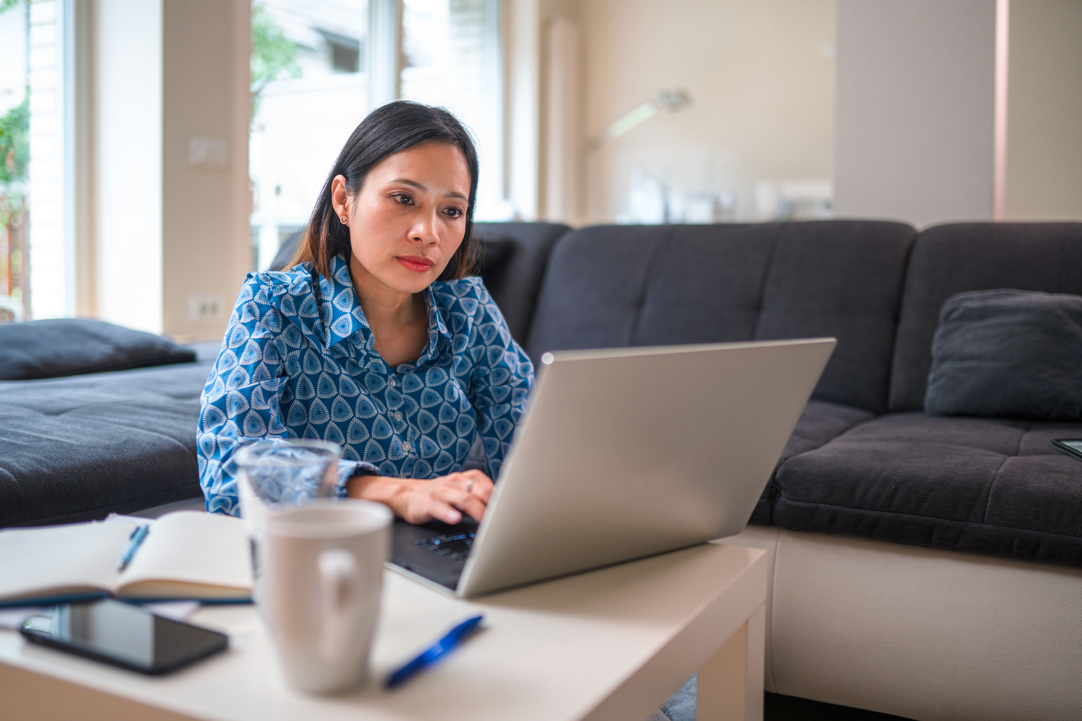 Businesswoman working on finances at home