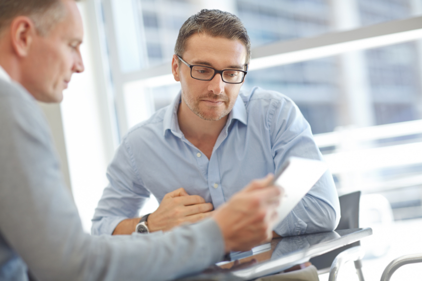 A pair of businessmen reviewing documents.