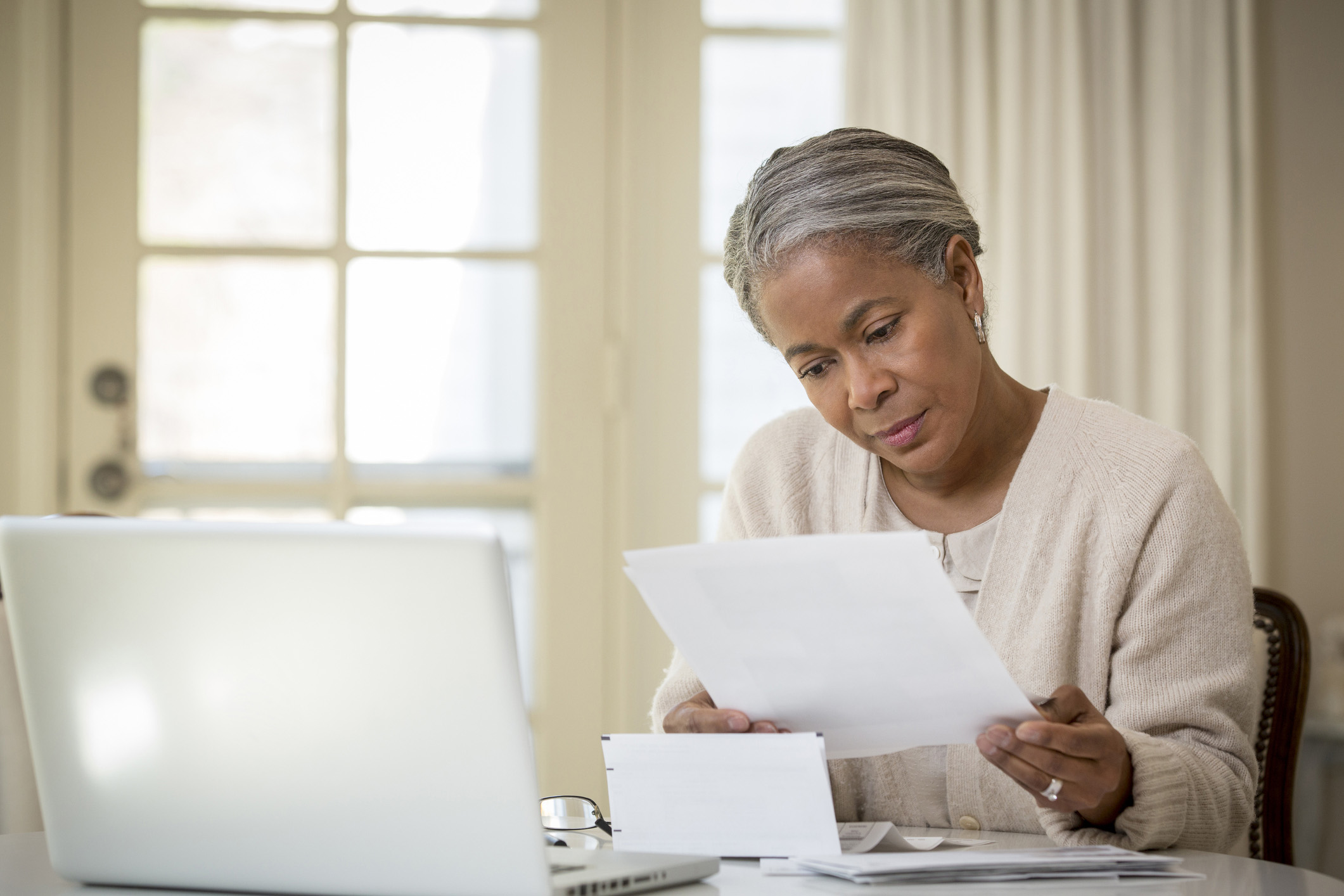 Senior woman paying bills