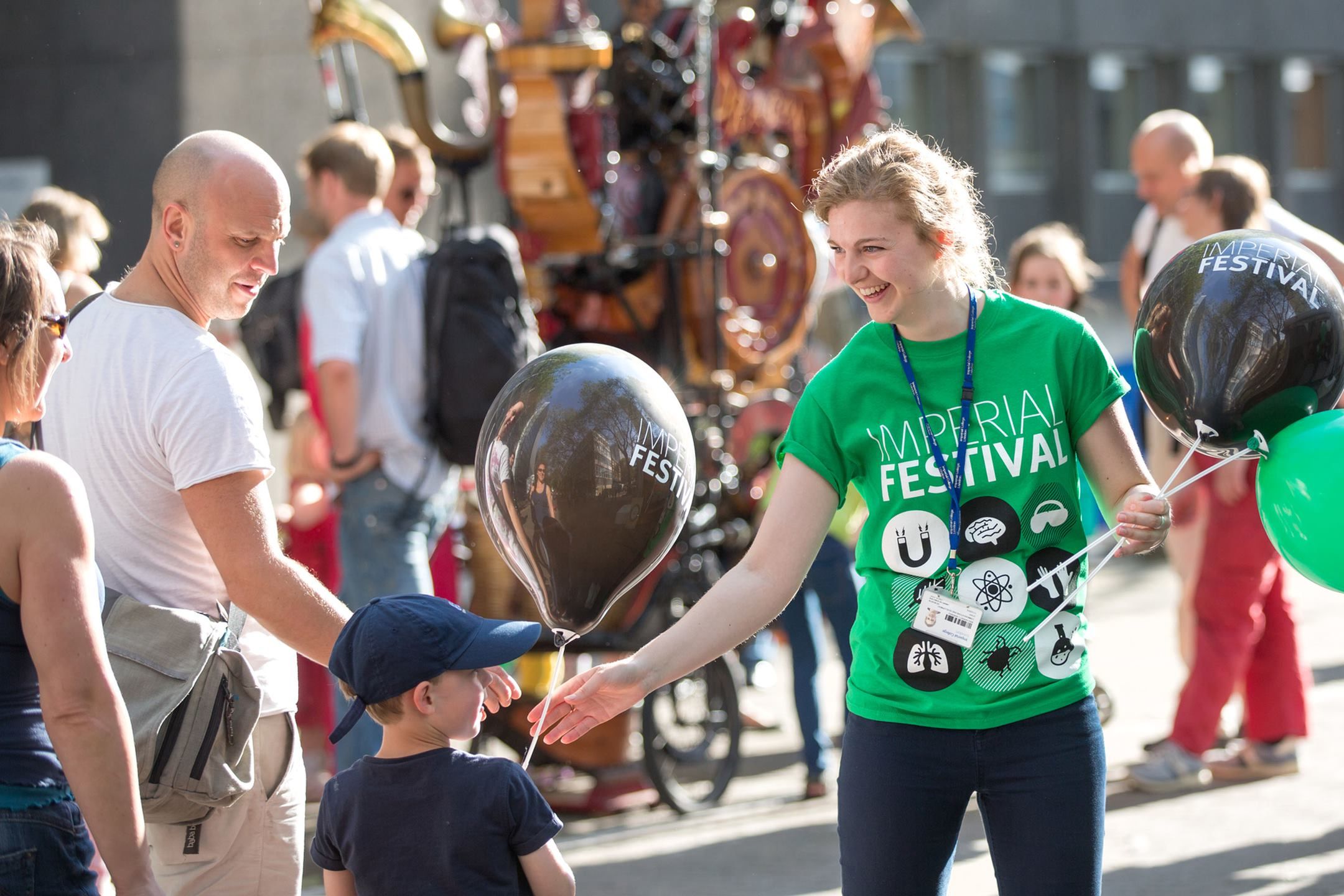 staff giving out balloons at imperial festival