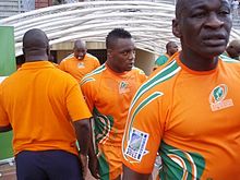 A close-up shot of the Ivory Coast players, in their country's orange jerseys, entering the field from the dressing room tunnel