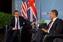 US President Barack Obama and British Prime Minister David Cameron trade bottles of beer to settle a bet they made on the U.S. vs. England World Cup Soccer game (which ended in a tie), during a bilateral meeting at the G20 Summit in Toronto, Canada, Saturday, June 26, 2010.