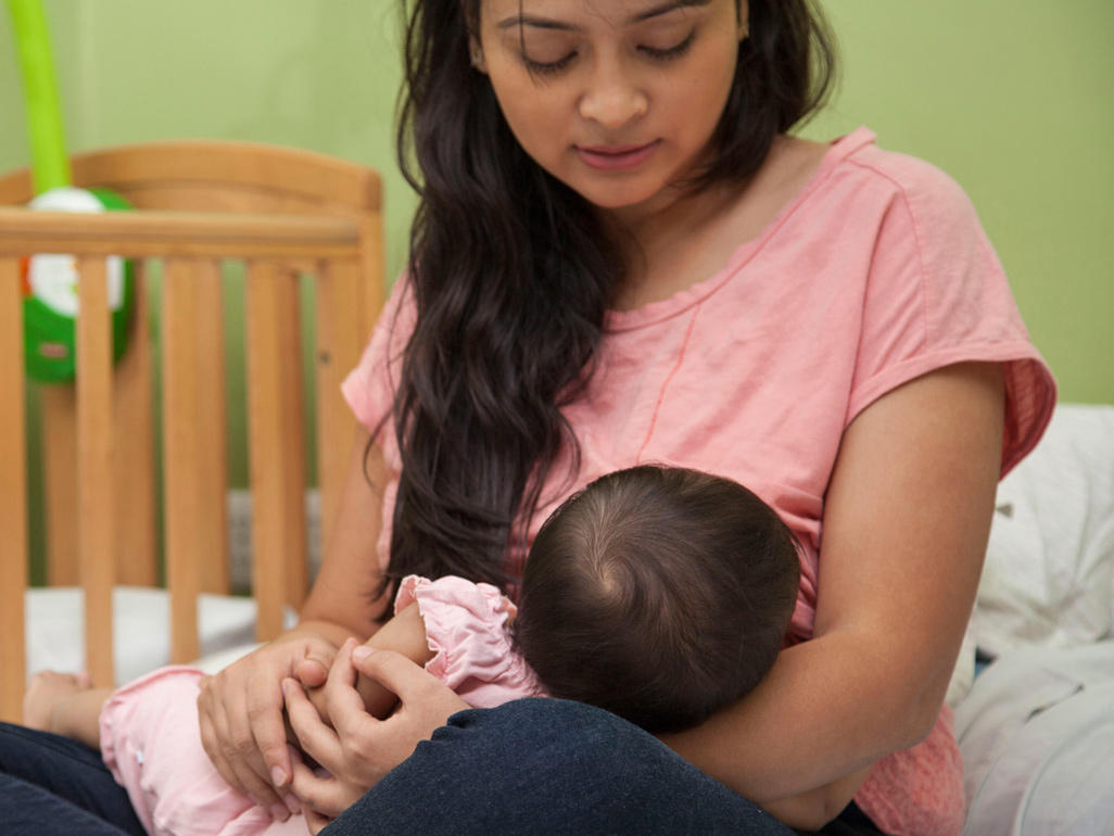 woman breastfeeding baby