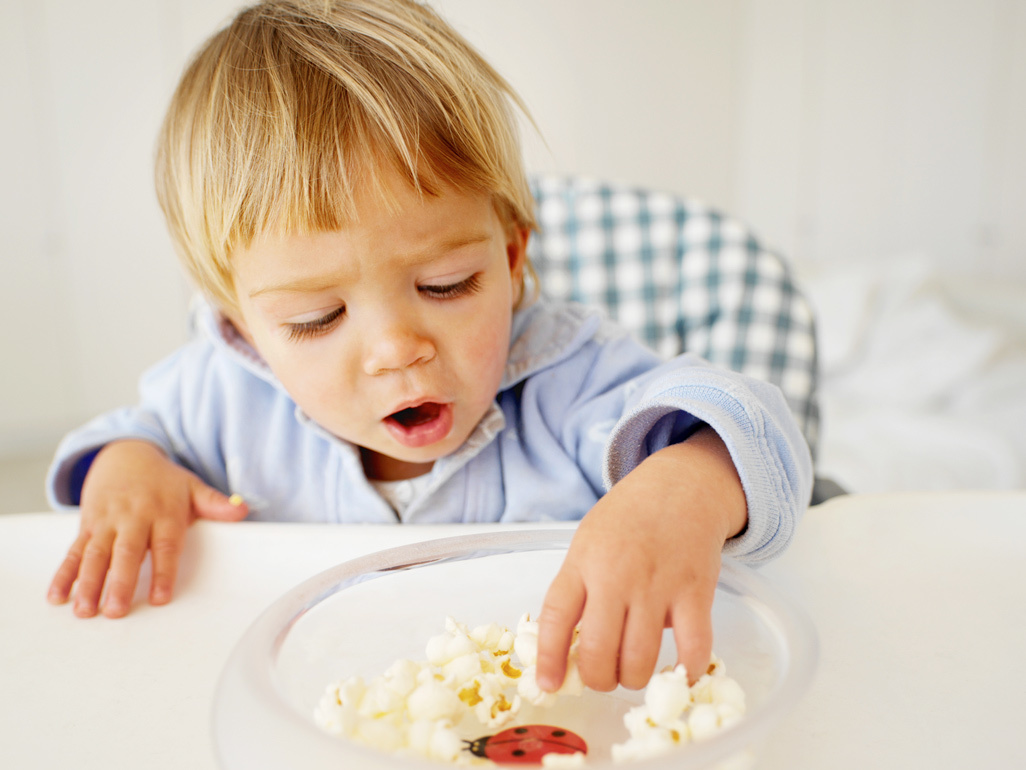 child eating popcorn