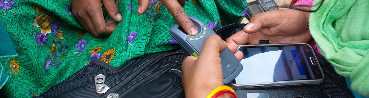 a person putting his finger on a wireless biometric scanner