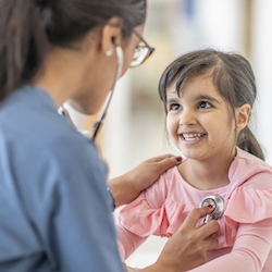 Girl getting heart checked by health care provider