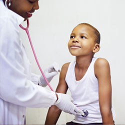 Provider listening to boy's stomach