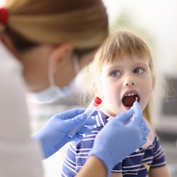 Provider swabbing child's cheek