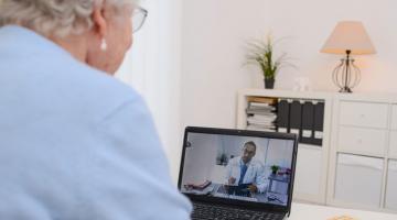 Older woman on telehealth video call with provider